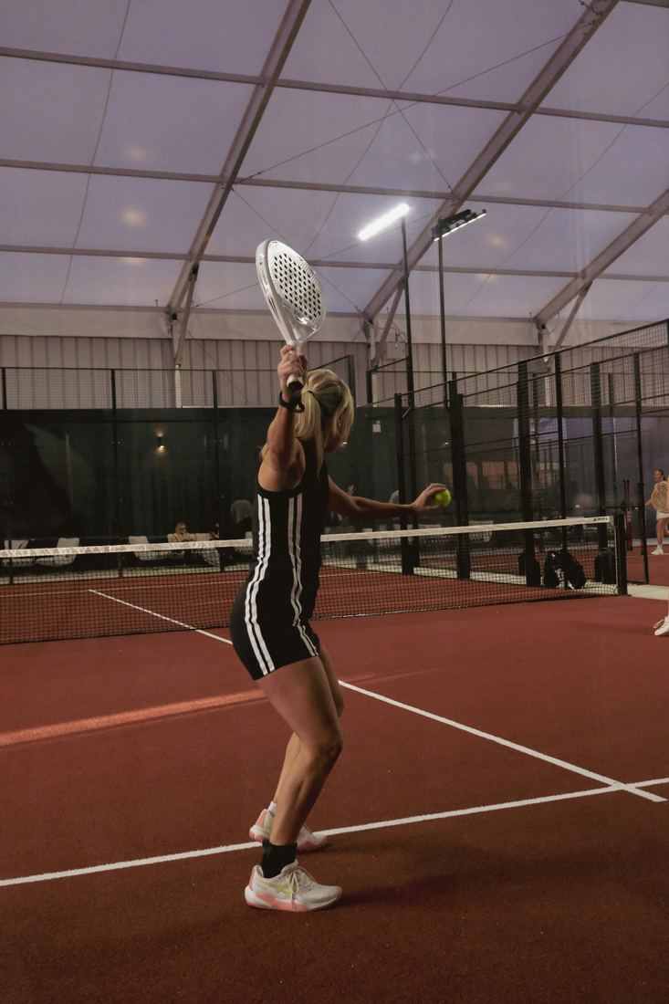 A player serving under the canopy